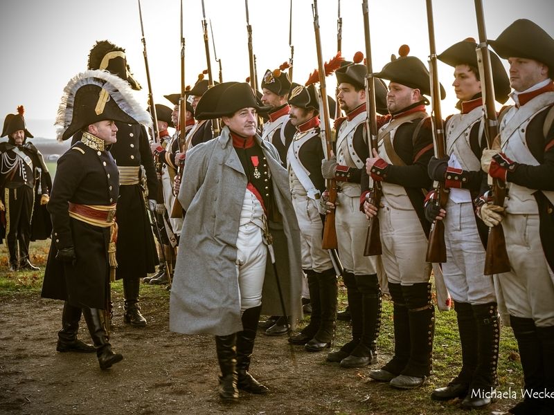 a group of people standing in front of a crowd posing for the camera
